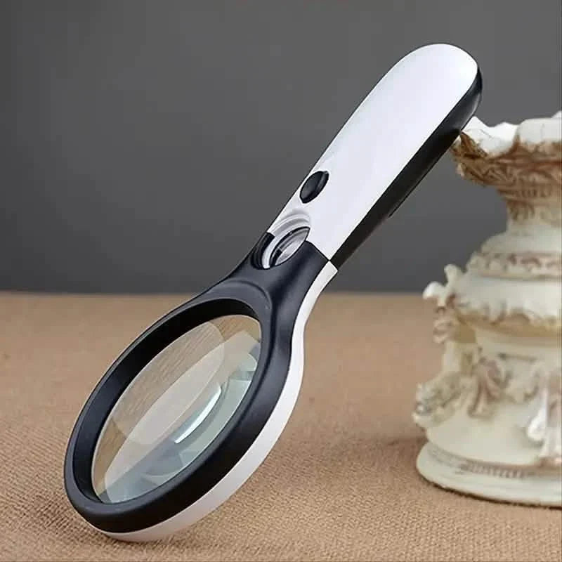 Handheld LED magnifying pocket microscope with white handle and black lens rim