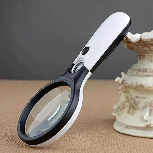 Handheld LED magnifying pocket microscope with white handle and black lens rim