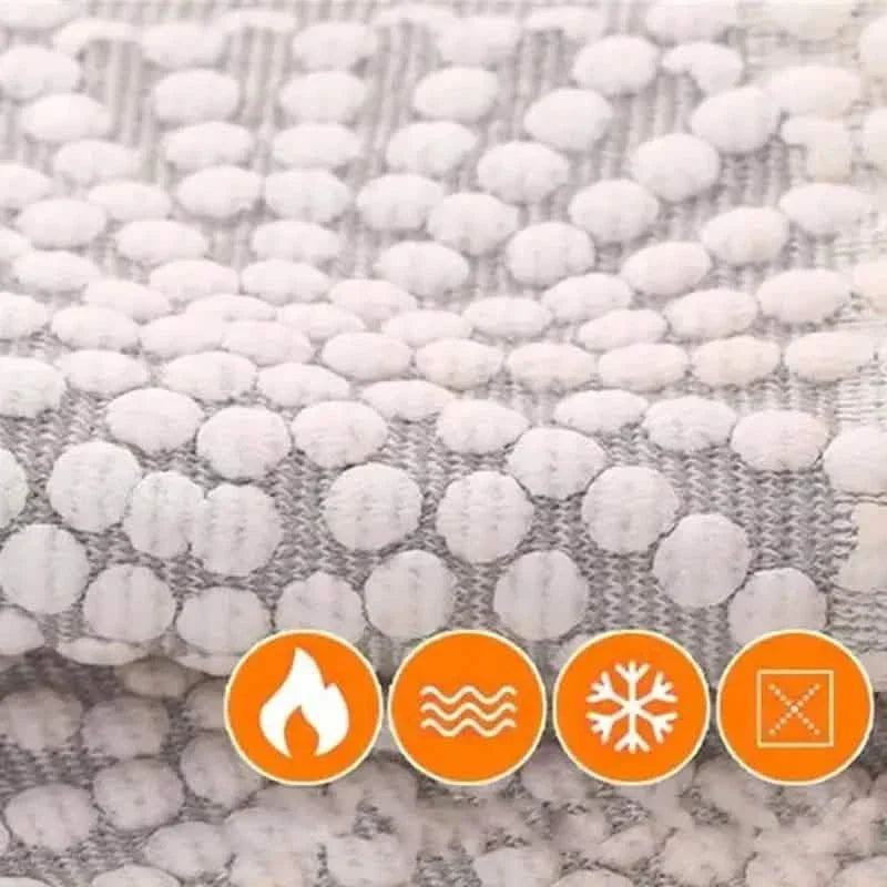Self-heating knee support pad material close-up, light gray with raised dot pattern