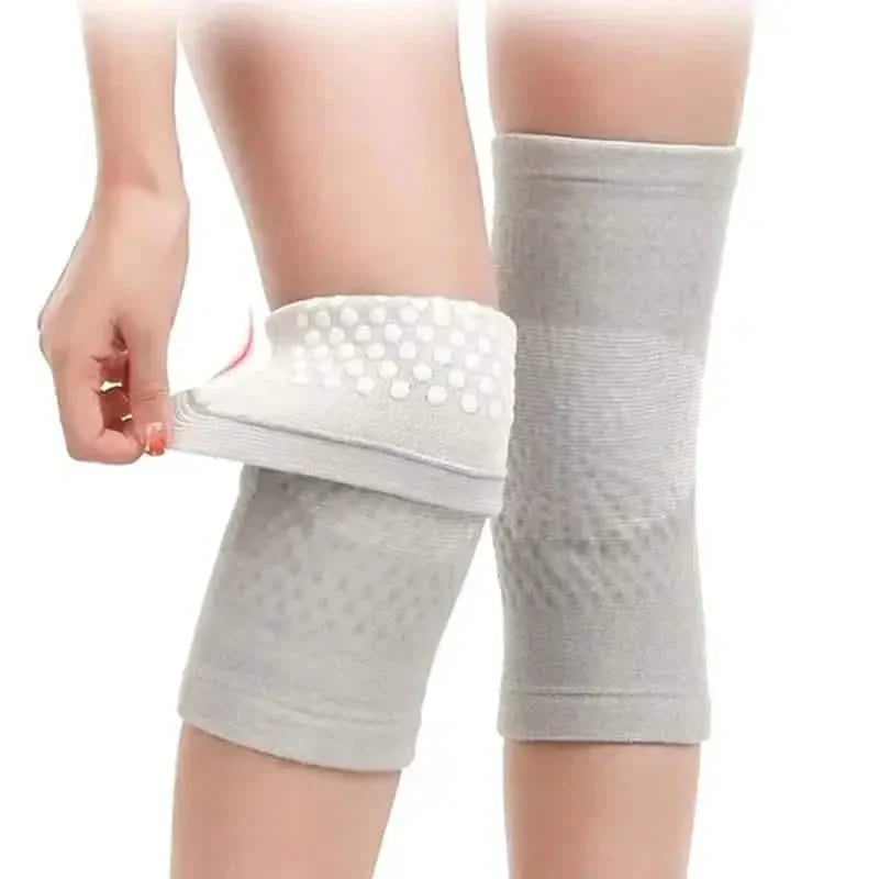 Self-heating knee support pads, light gray sleeves with white dot grip on leg