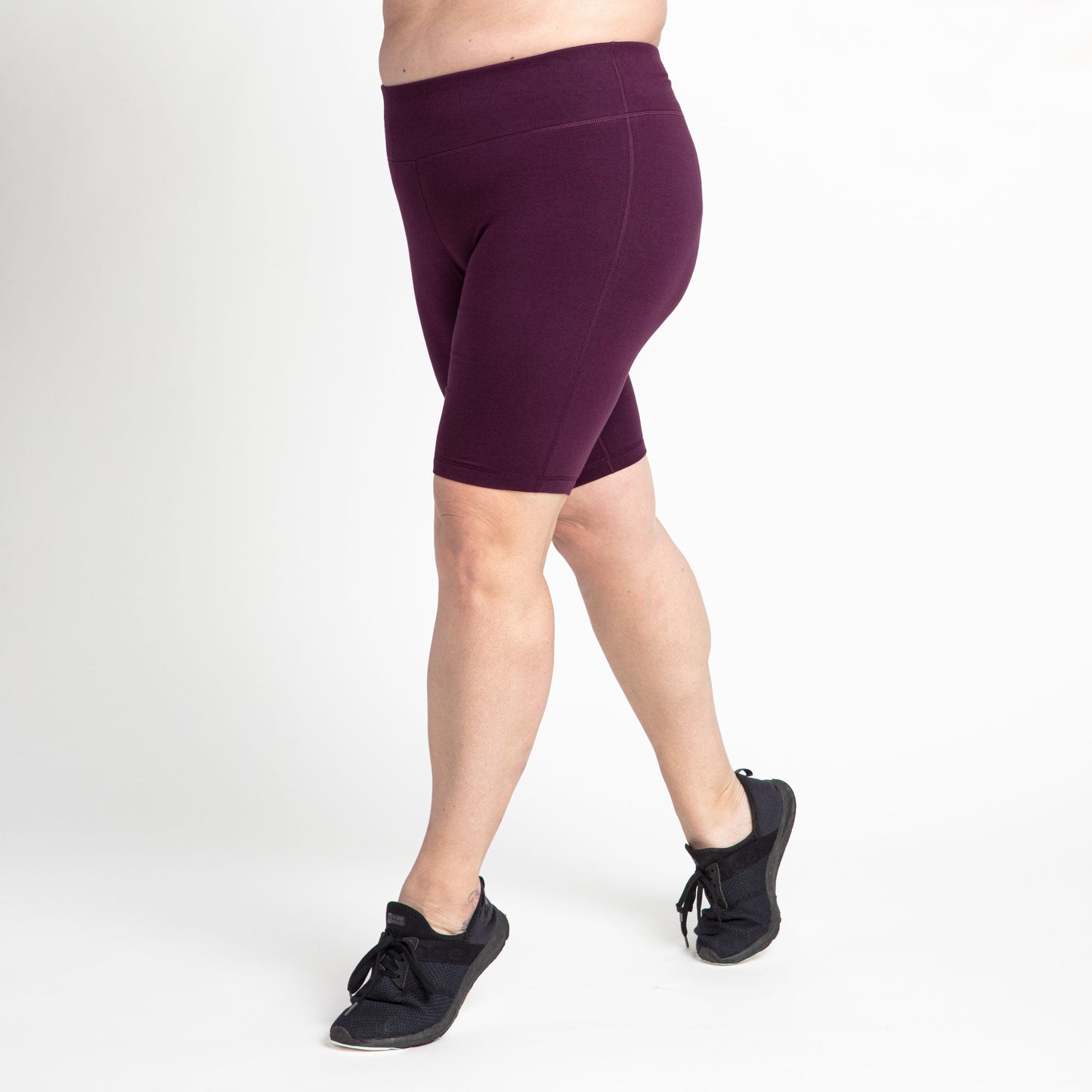 Burgundy bike shorts, rear view, mid-thigh length with seam stitching