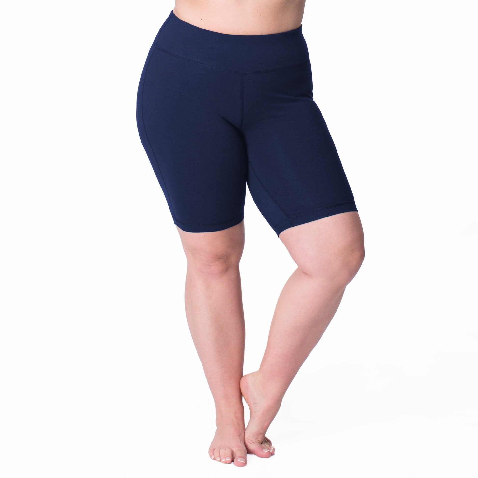 Navy bike shorts, mid-thigh length with contoured seams and small logo at waist