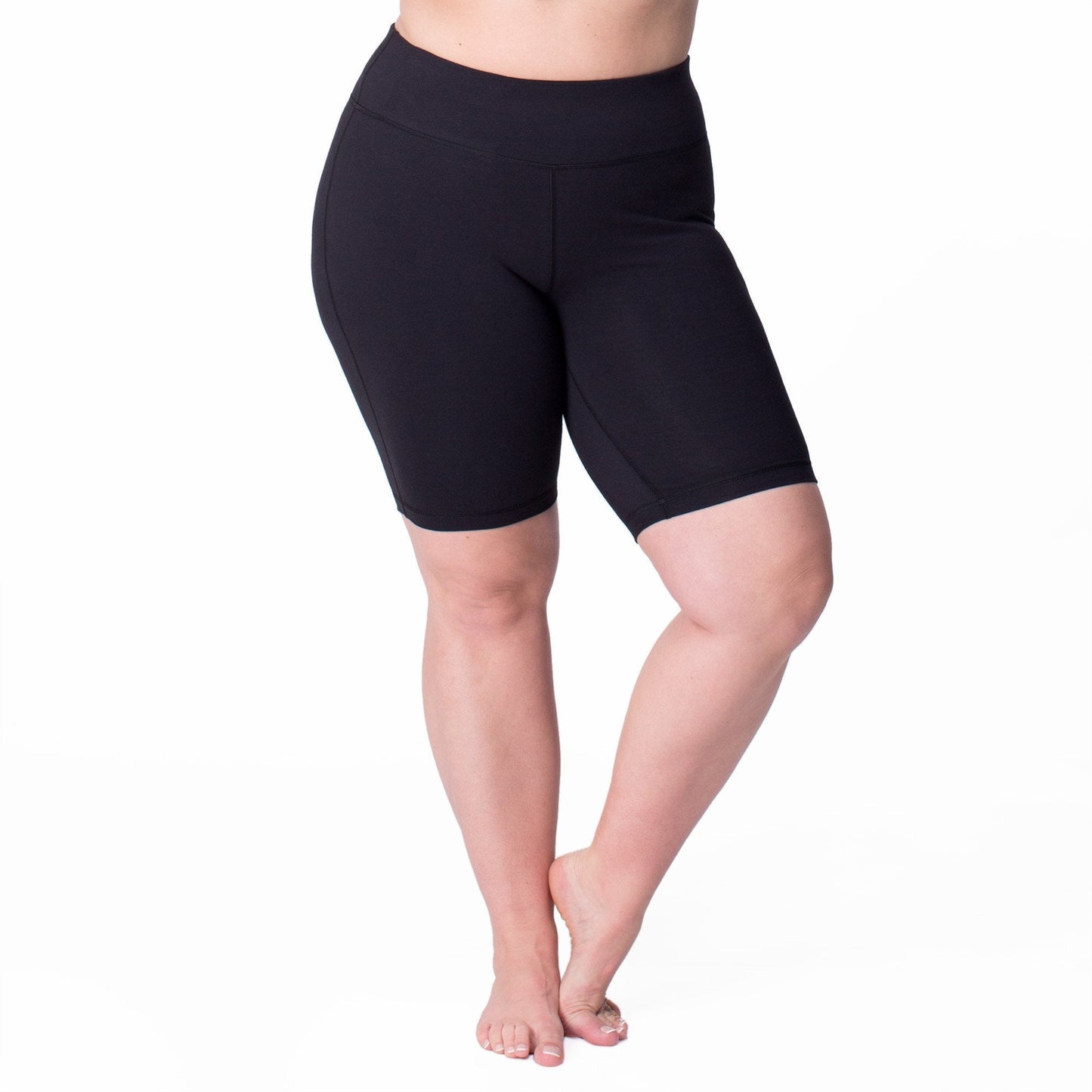 Dark bike shorts, mid-thigh length with flat front waistband and small logo