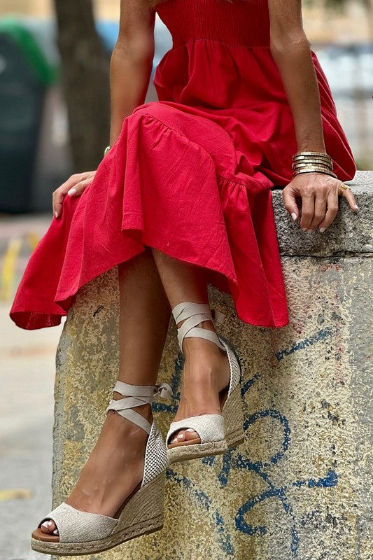 Red smocked maxi dress with ruffled shoulders and tiered skirt, sleeveless