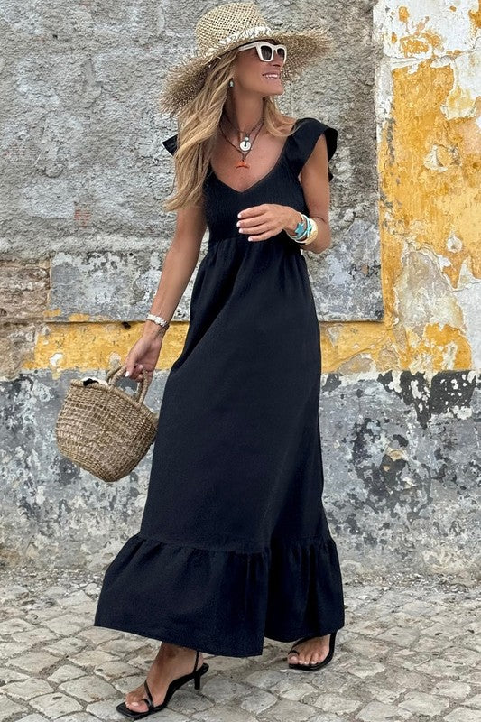 Black smocked maxi dress with V-neck, gathered bodice, and tiered hem
