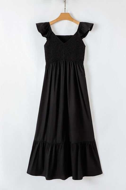 Black maxi dress on hanger, square neckline, ruffled cap sleeves, tiered skirt.
