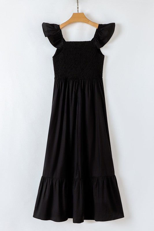 Black maxi dress front view, smocked bodice, ruffled cap sleeves, tiered skirt.