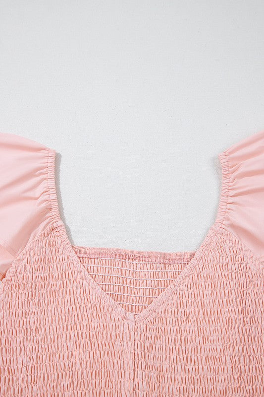Peach smocked bodice with wide V neckline and gathered texture