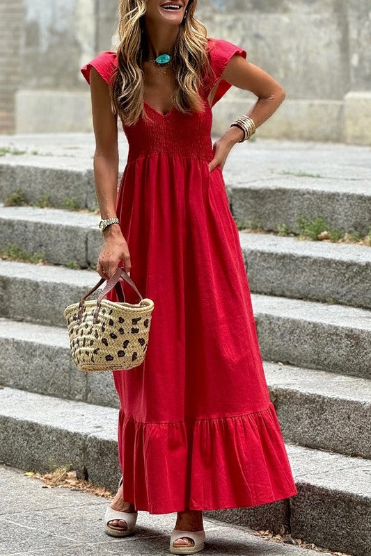 Red maxi dress with V-neck smocked bodice, short ruffled sleeves, and tiered hem.