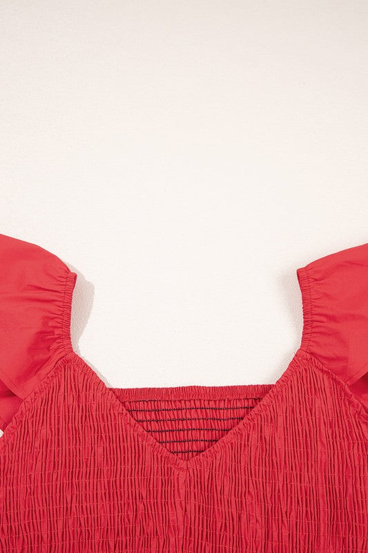 Red smocked neckline bodice with textured fabric and elastic trim