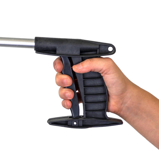 Hand holding 24" grabber tool: black ribbed jaw clamp, trigger, silver shaft