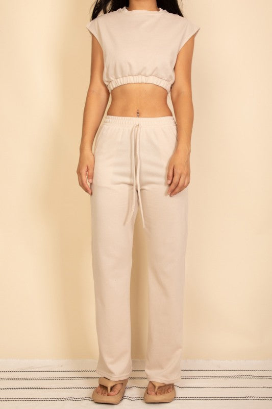 Cream sleeveless crop top with elastic hem and wide-leg drawstring pants set