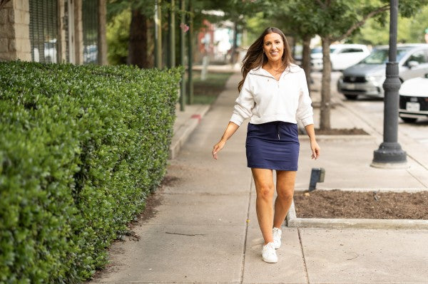 Navy jogger-style skirt with adjustable drawstring waist and smooth knit fabric.