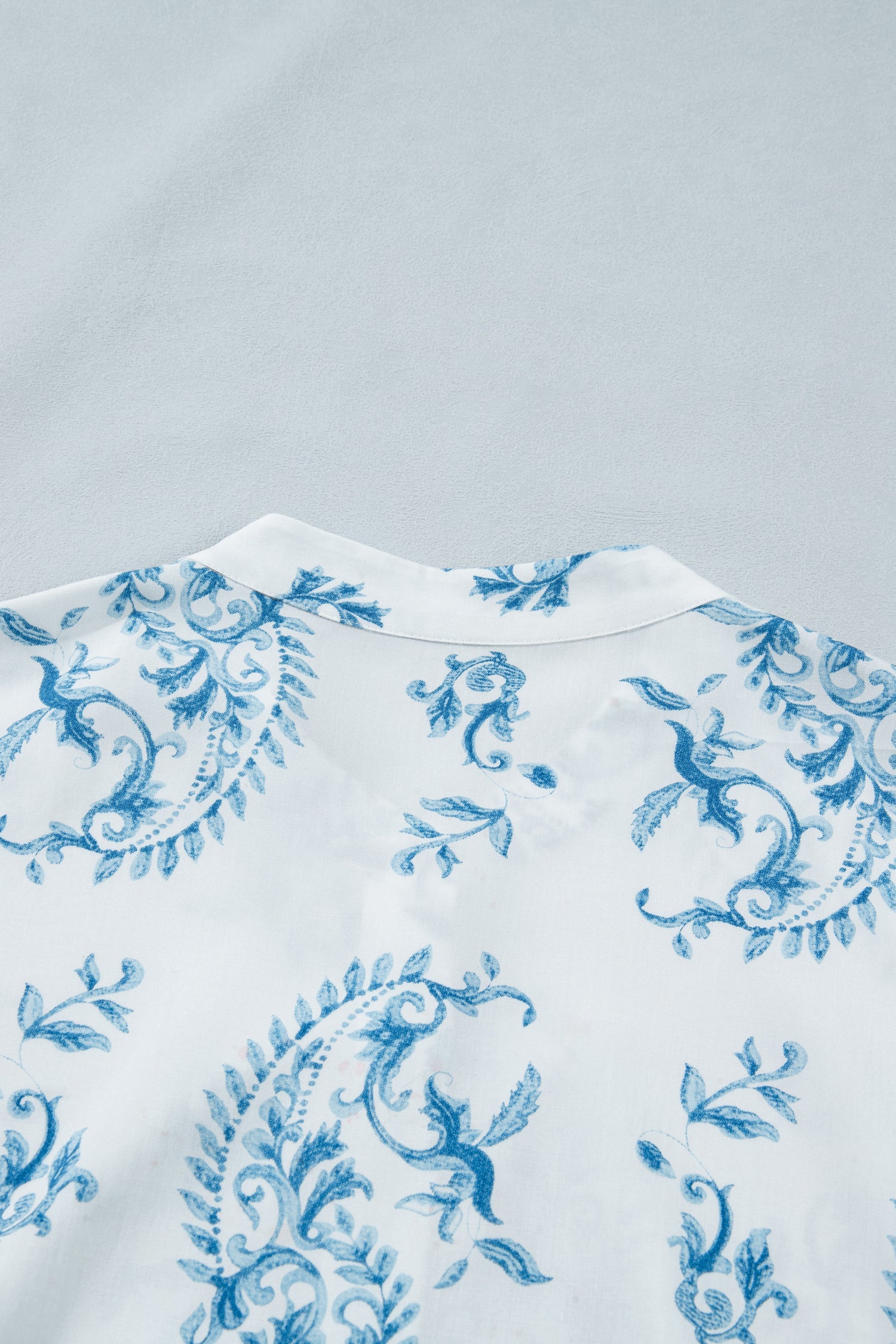 Sky blue floral print short sleeve dress top with crew neckline and gathered trim