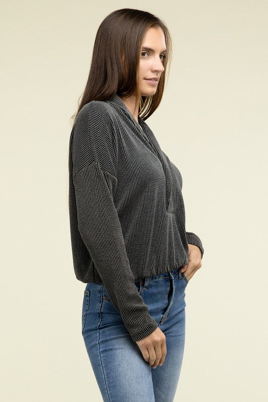 Black textured knit pullover top with shawl collar and button front, side view