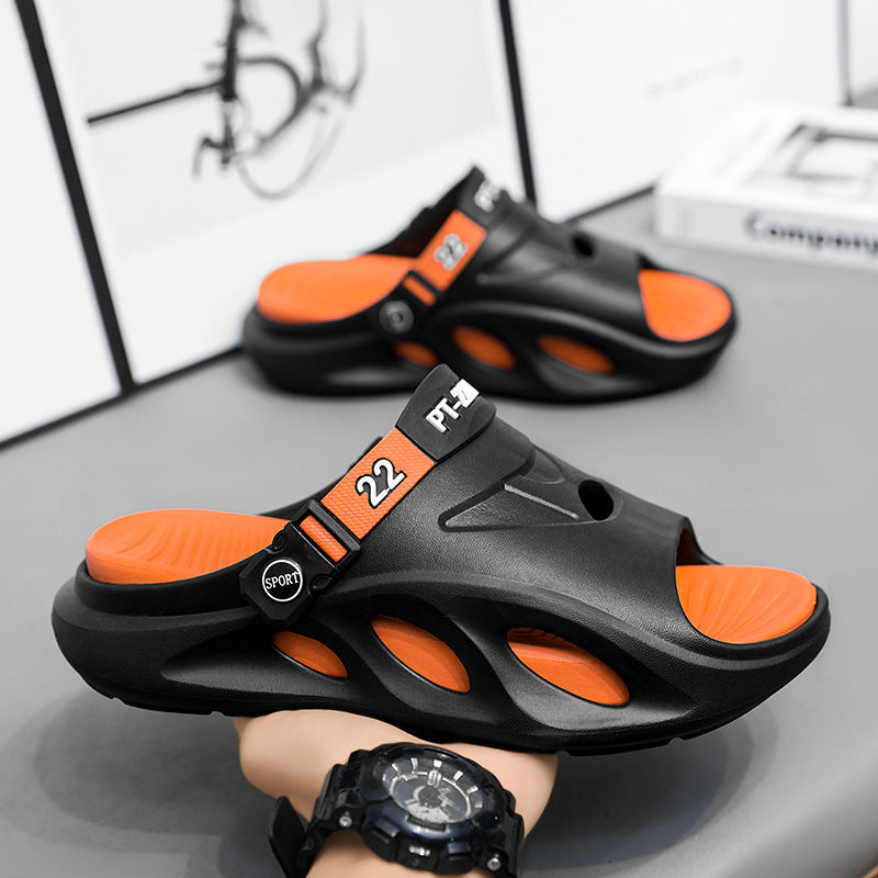 Black slide sandals with orange adjustable strap and openwork cutouts on upper