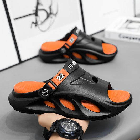 Black slide sandals with orange adjustable strap and openwork cutouts on upper