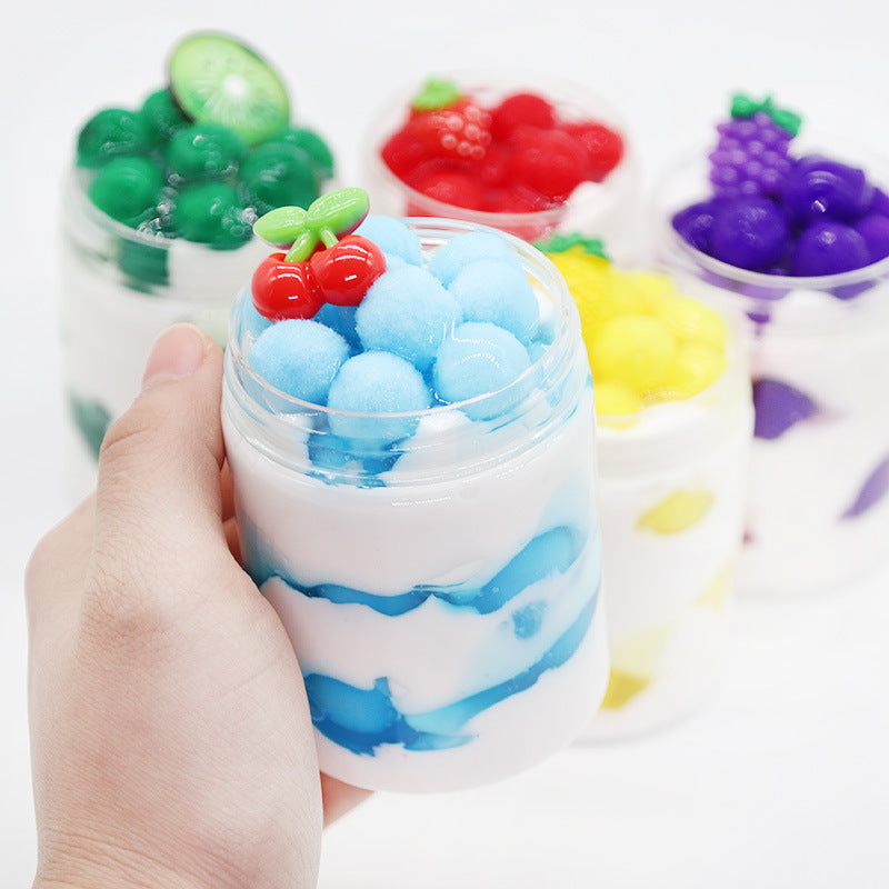 Blue slime cup with red cherry-like candy and green leaf topper