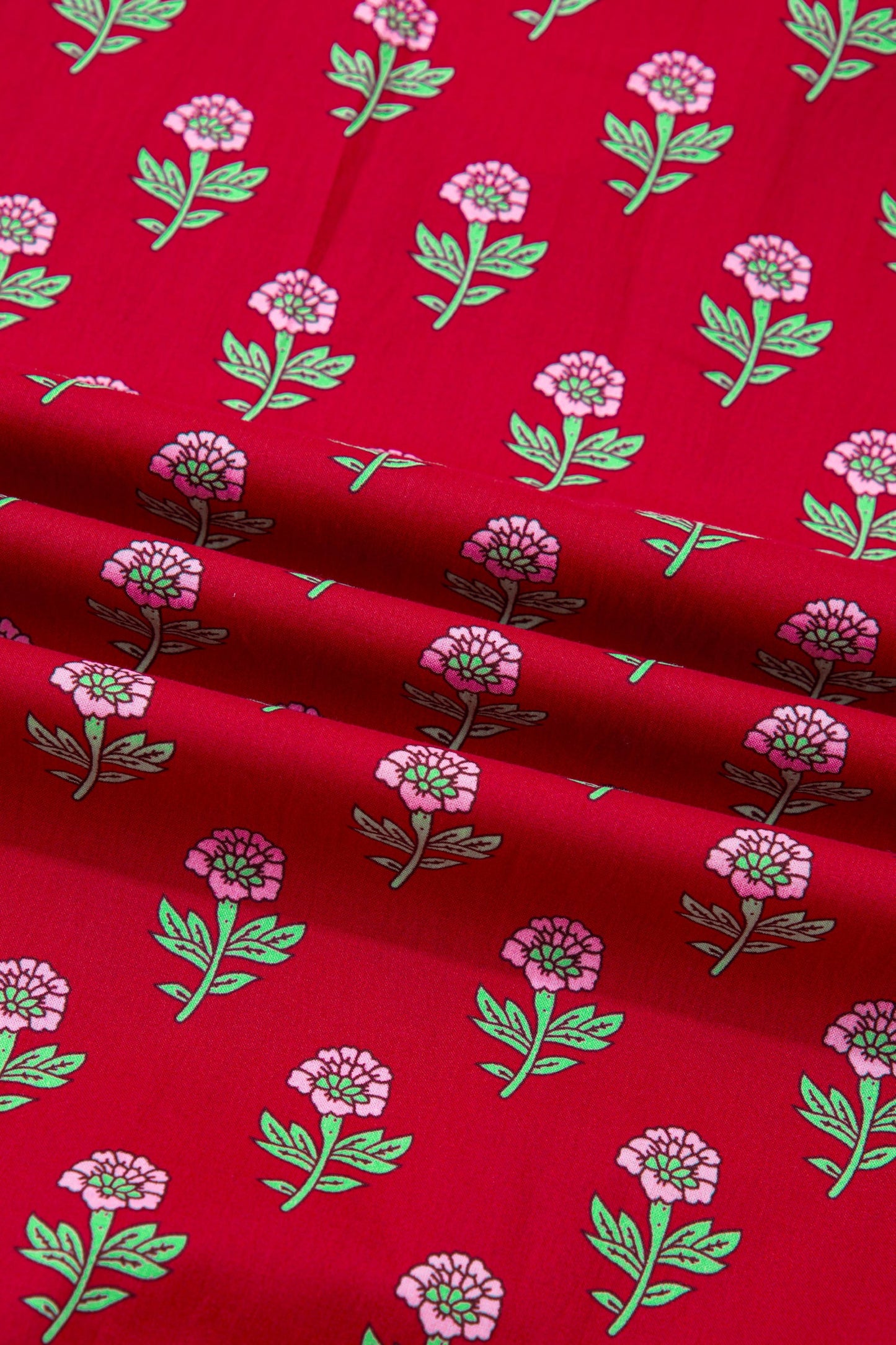 Red fabric with small pink flowers and green vine pattern