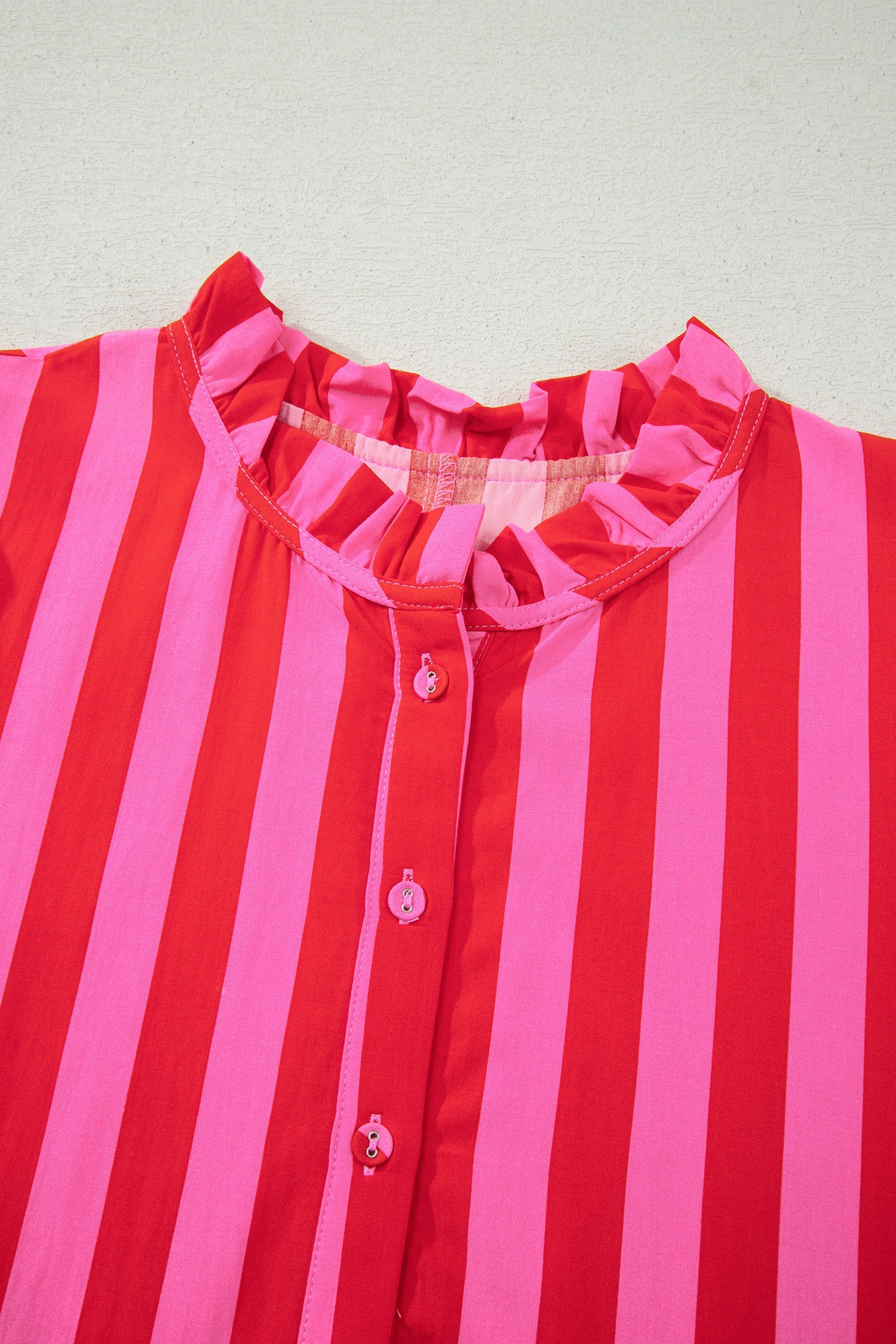 Pink and red striped mini dress with ruffled yoke and button front