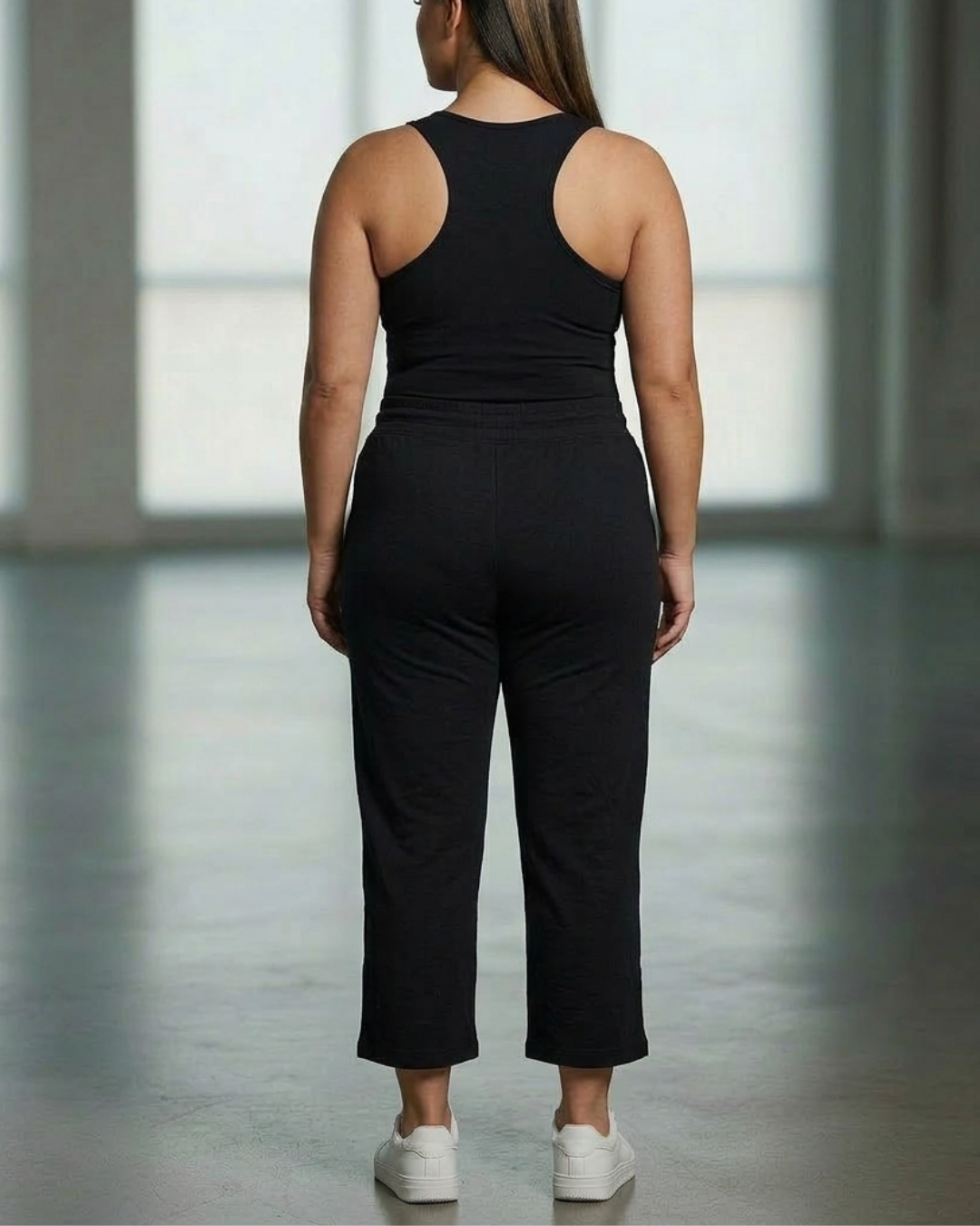 Relaxed capri pants, black with drawstring elastic waist; cropped straight legs.