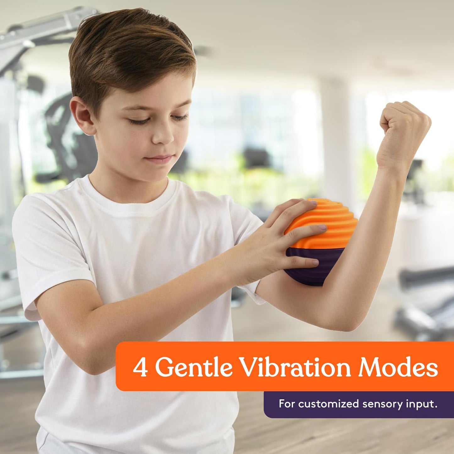 Orange and purple vibration massage ball held in a child’s hands