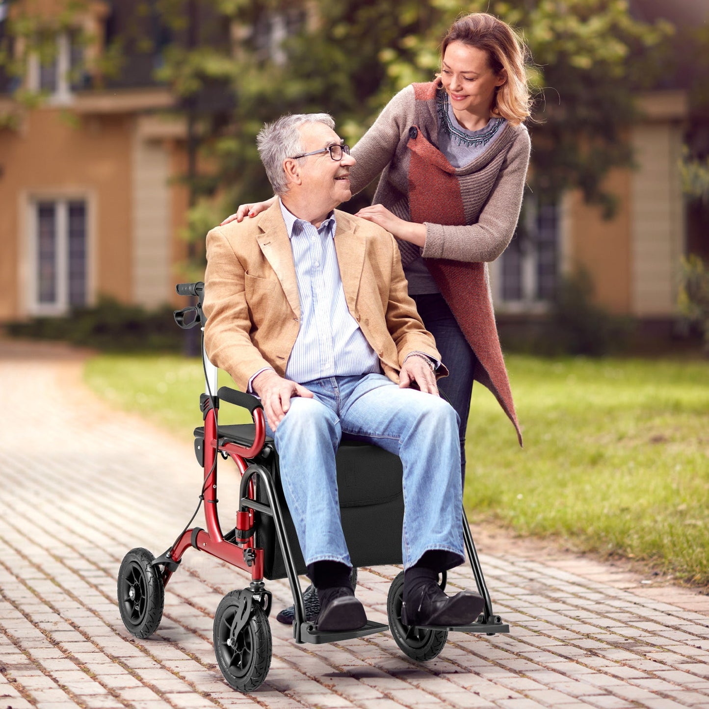 Woman pushing an elderly man in a wheelchair outdoors on a sunny day.