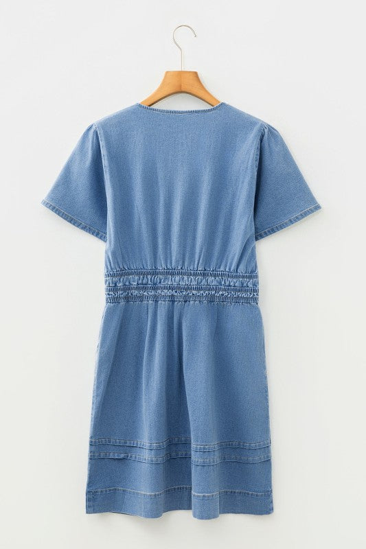 Denim mini dress with elastic waist and short sleeves, light blue back view