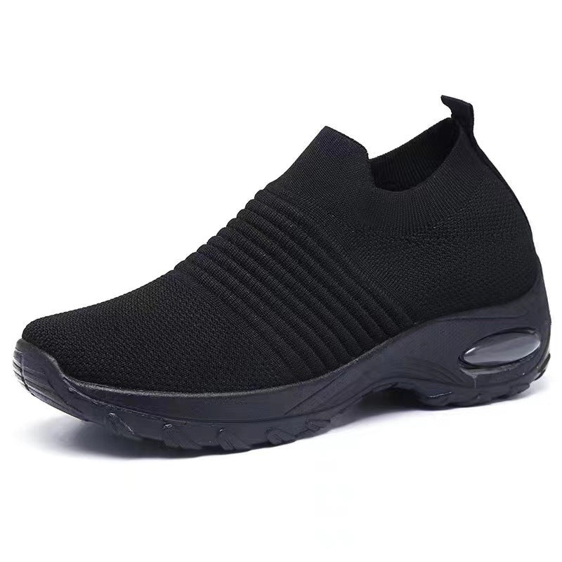 Black knit slip-on sneakers with ribbed texture and visible air-cushion window