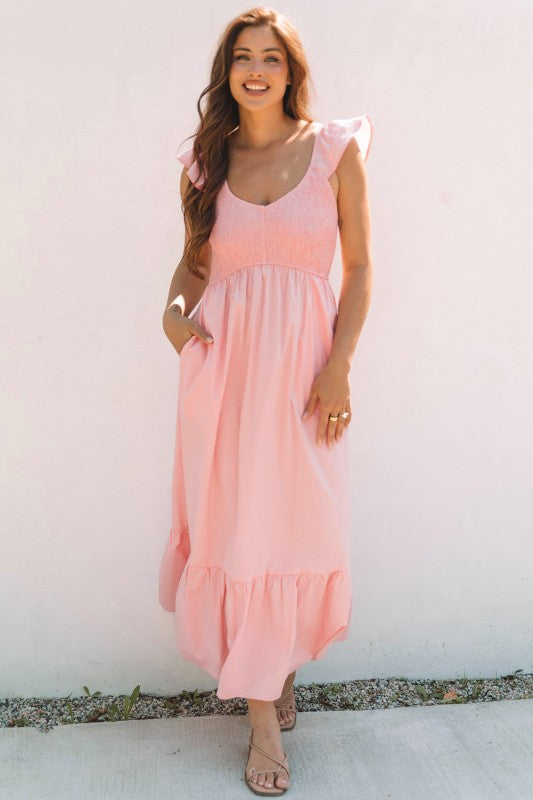 Apricot pink maxi dress with smocked bust, flutter sleeves, and gathered tiered skirt