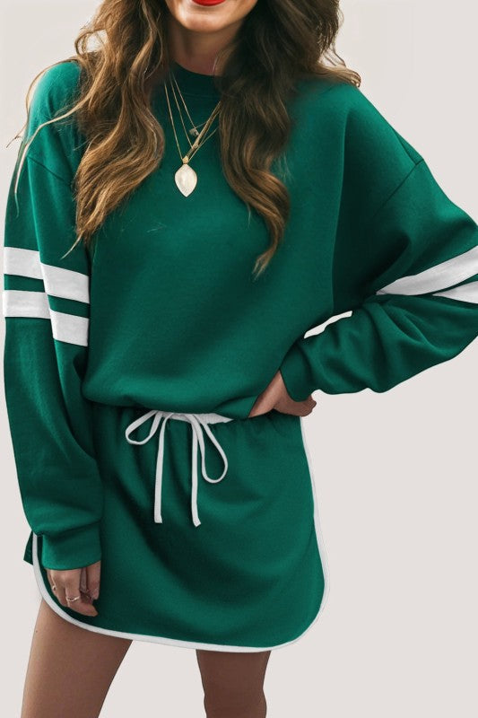 Green varsity pullover with white striped cuffs and drawstring mini skirt