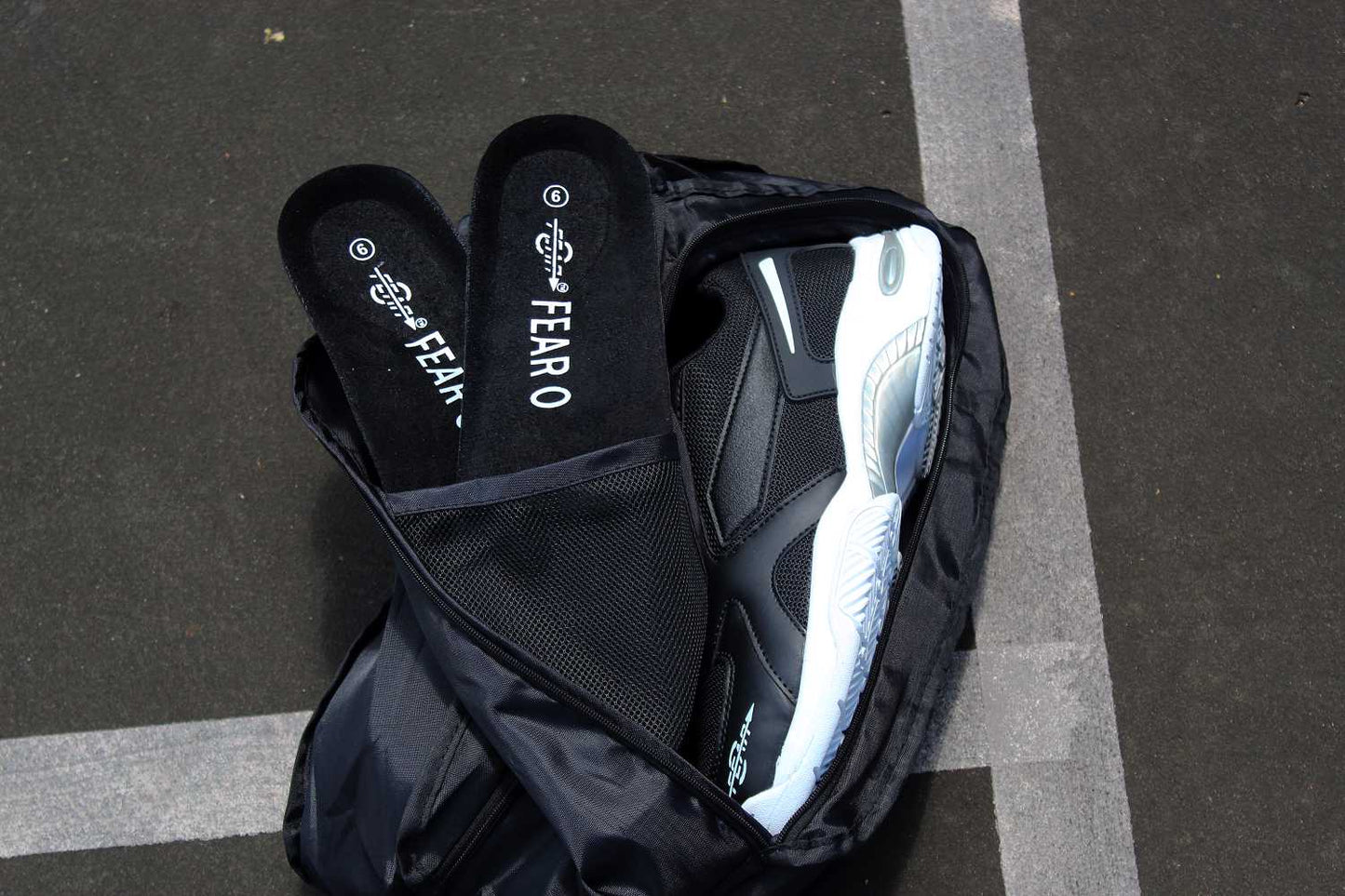 Men’s black walking shoes with white tread sole, lying on their sides