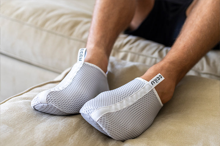 White slip-on socks shoes with textured fabric sides and soft rubber sole
