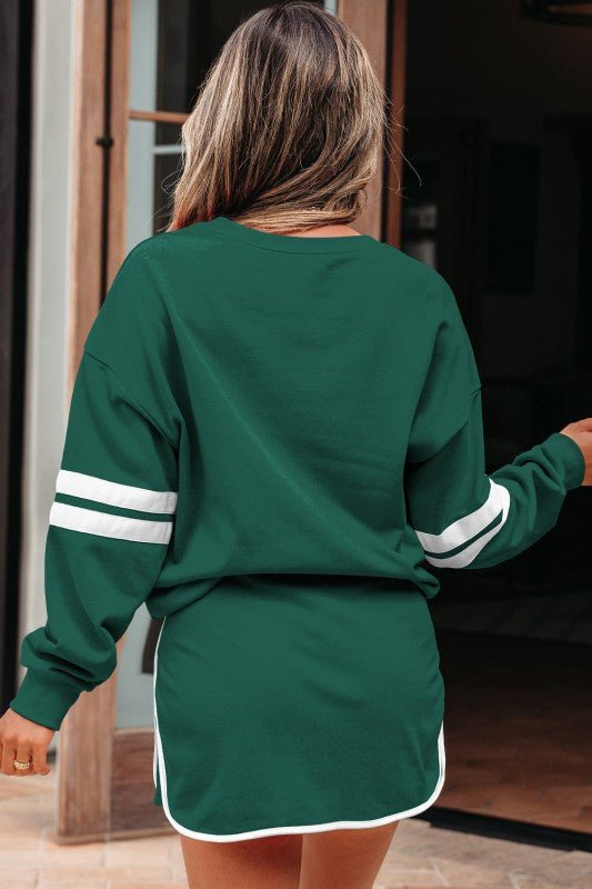 Green varsity pullover and mini skirt set, back view with white stripe sleeves