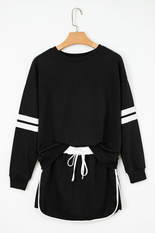 Black pullover sweatshirt and mini skirt set with white striped sleeves and drawstring waist