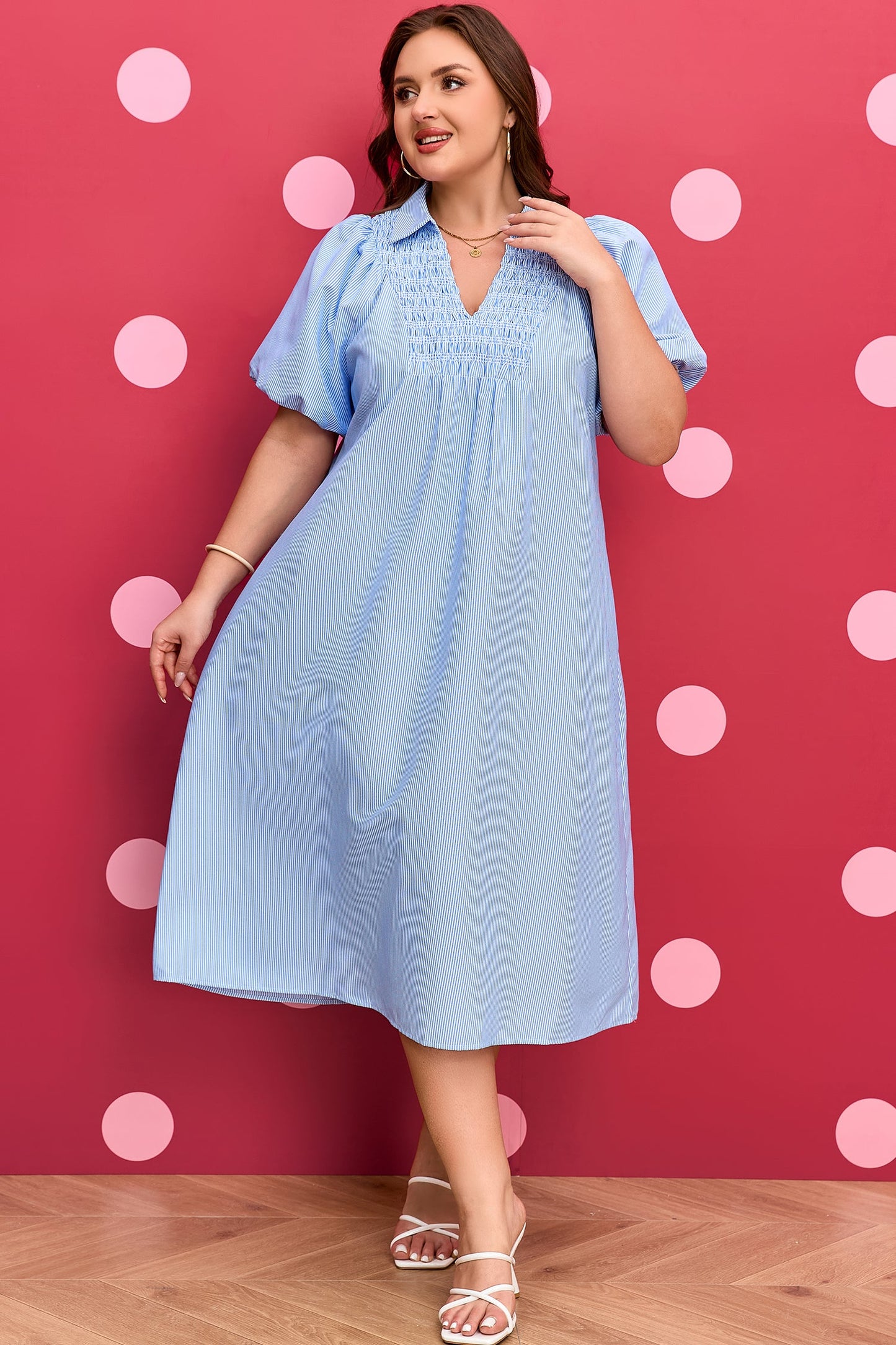 Plus-size light blue striped midi dress with V-neck and short puff sleeves; upper-body view.