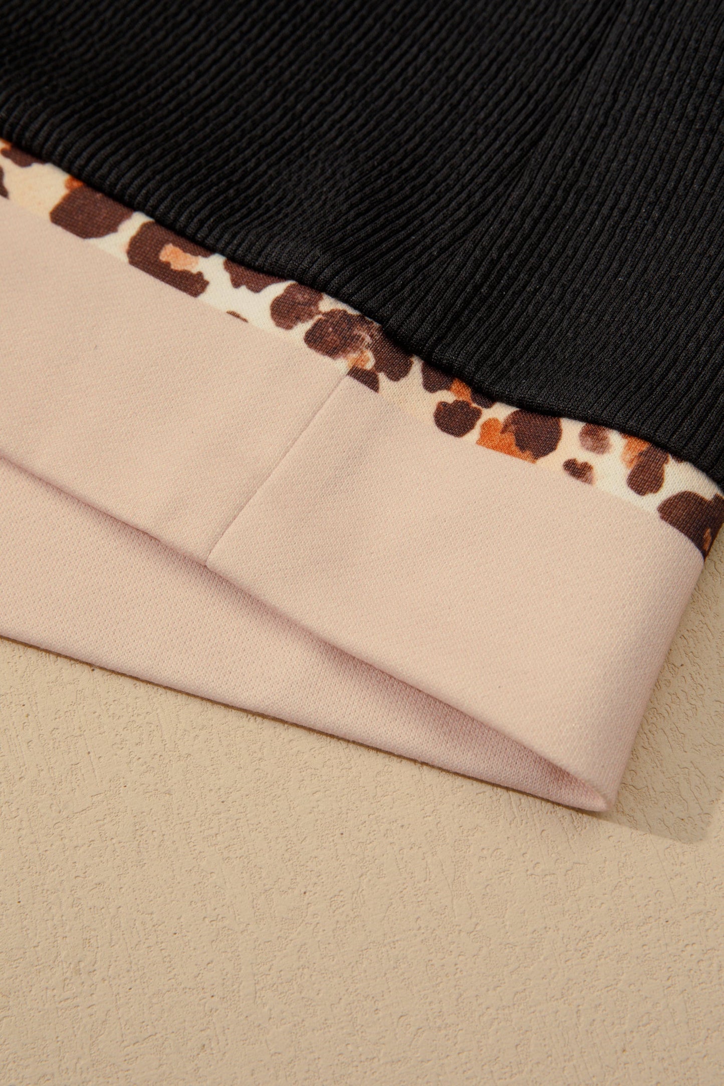 Black ribbed hem with cream panel and leopard block trim edging