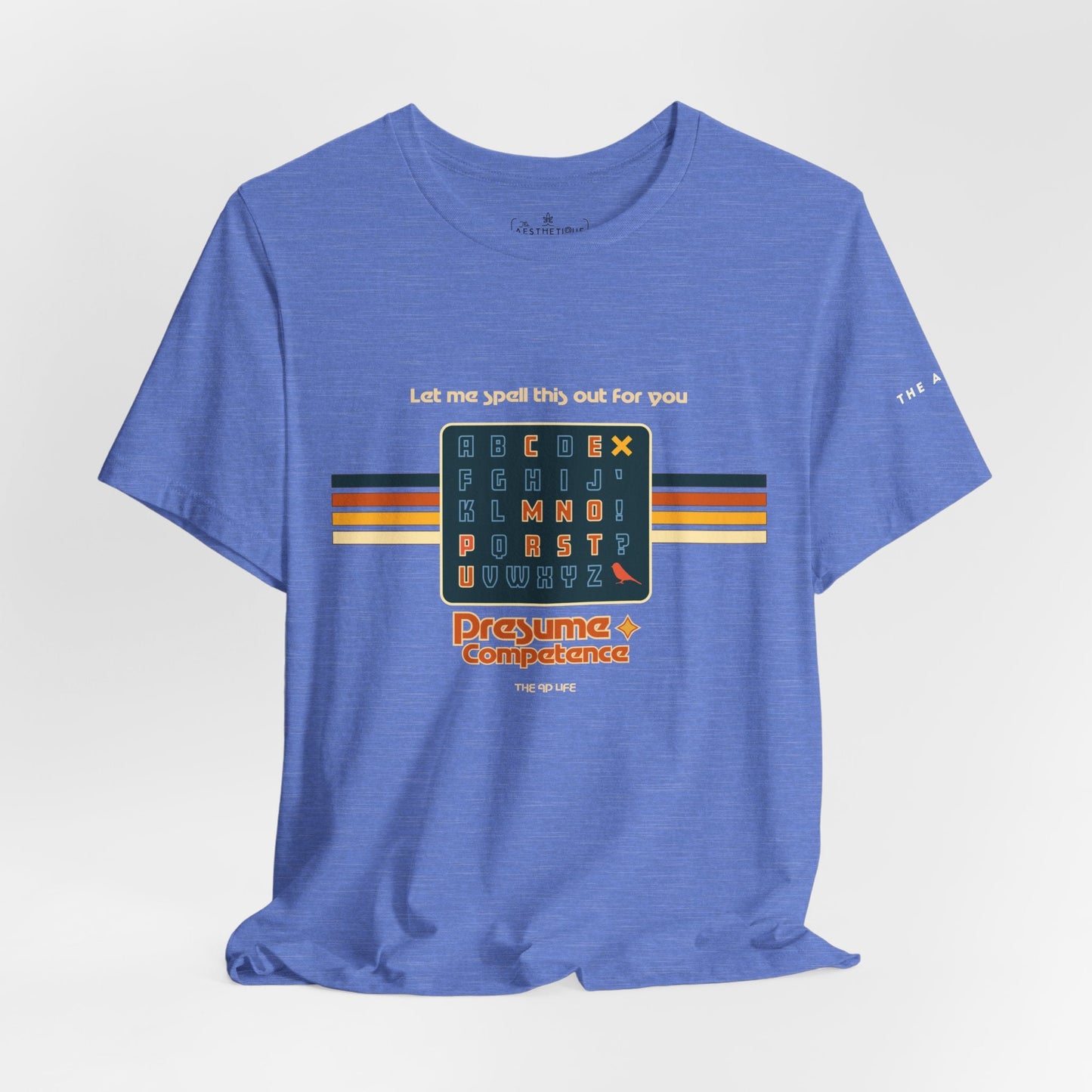 Heather blue unisex jersey tee with spelling-themed letter grid graphic on front; knotted hem