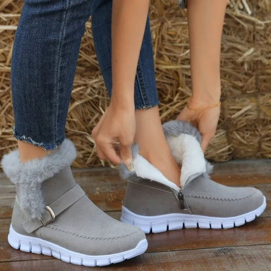 Grey ankle snow boots with plush trim, side zipper, buckle strap, thick white sole
