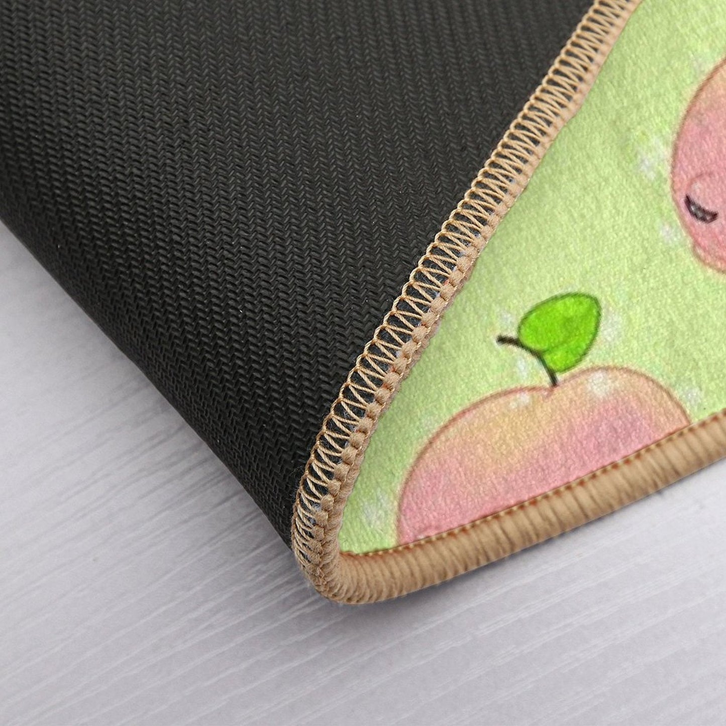 Peach frog bath mat corner close-up with stitched border and pink frog print