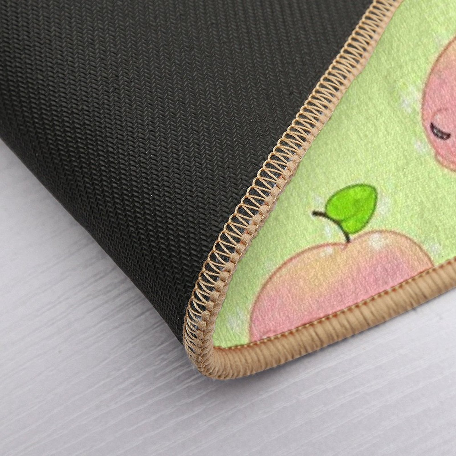Peach frog bath mat corner close-up with stitched border and pink frog print
