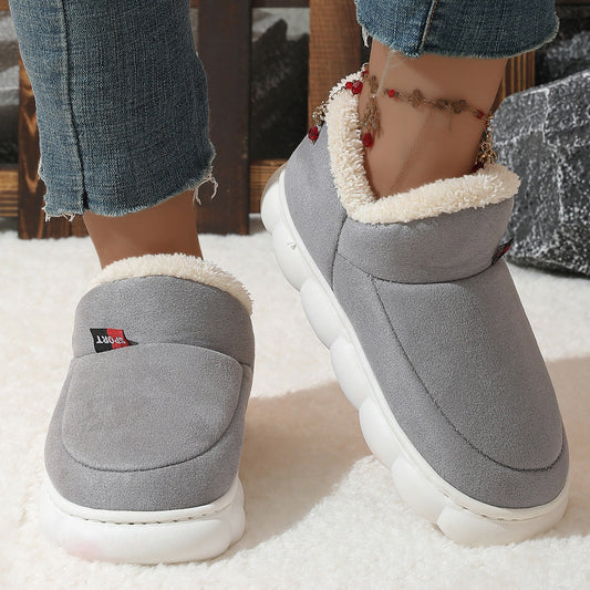 Grey plush house shoes with fuzzy strap and thick white sole, back view