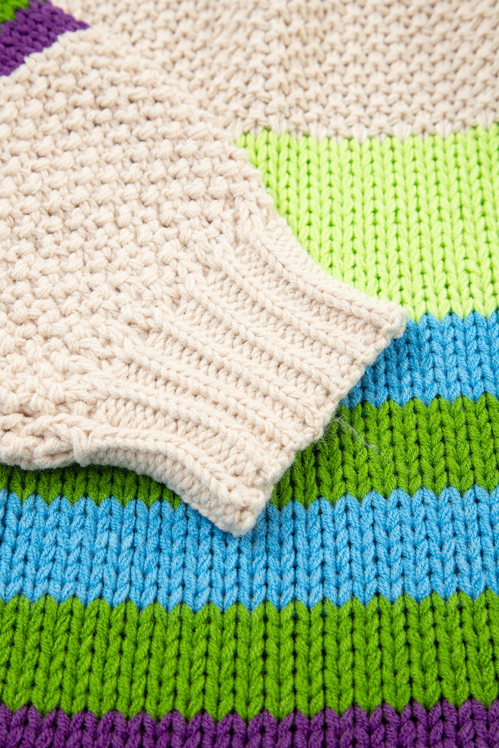 Cream crochet cardigan with ribbed striped bands in blue, green, and purple