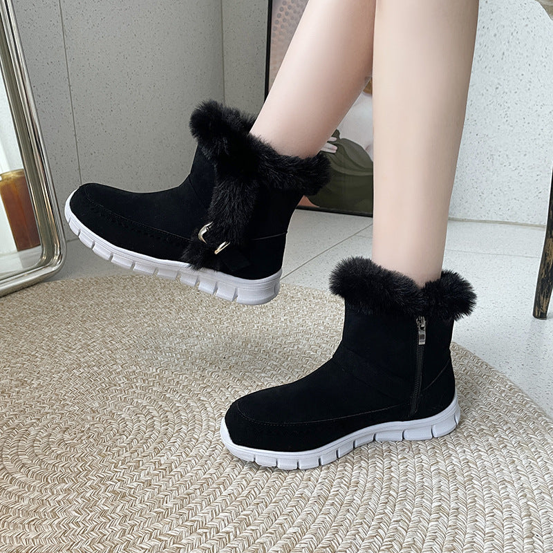 Black ankle snow boots with faux fur cuff, side zipper, buckle detail, chunky white sole