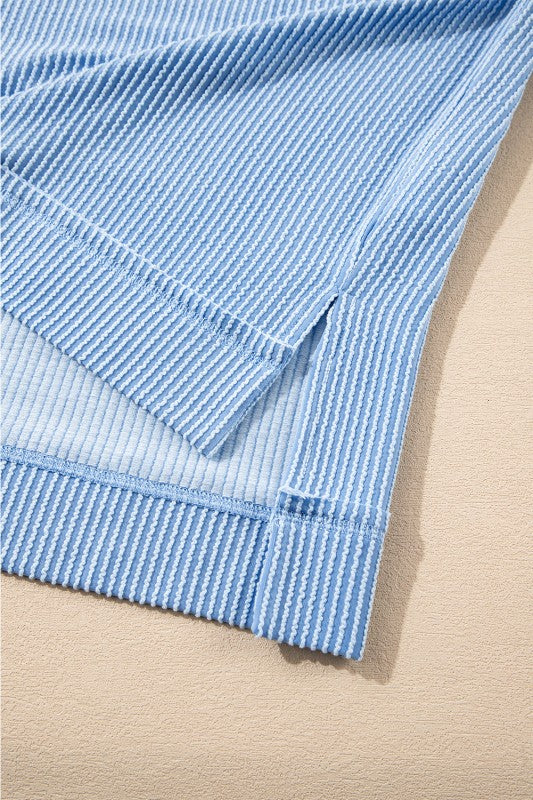 Light blue corded knit sleeve cuff and ruffle mini skirt hem with gathered trim