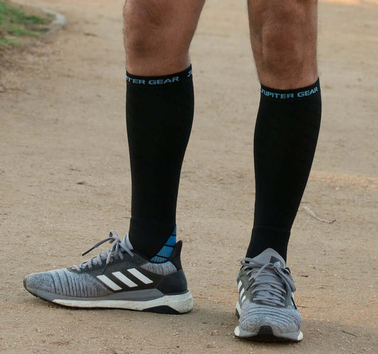 Black compression running socks with blue cuff stripe and light blue heel/toe accents