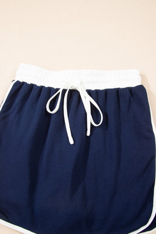 Navy mini skirt with white-trim edges and drawstring waist ties.