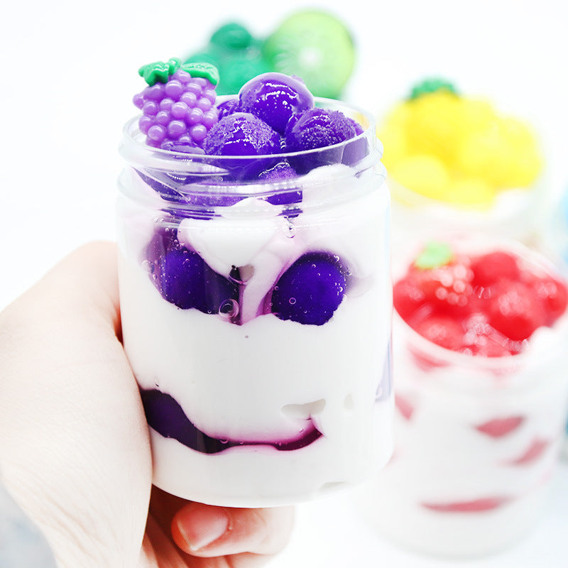 White slime cup with purple grape-like chunks and colorful candy sprinkles