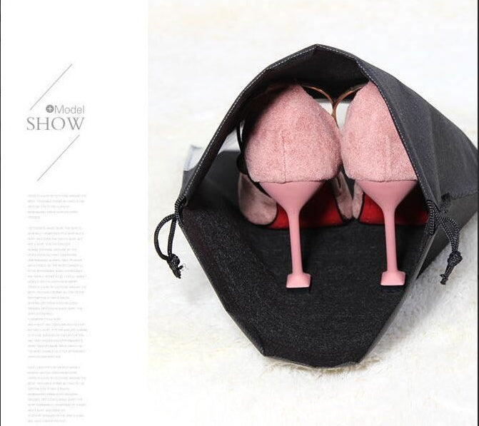 Black drawstring shoe storage bag with clear window, holding pink high heels.