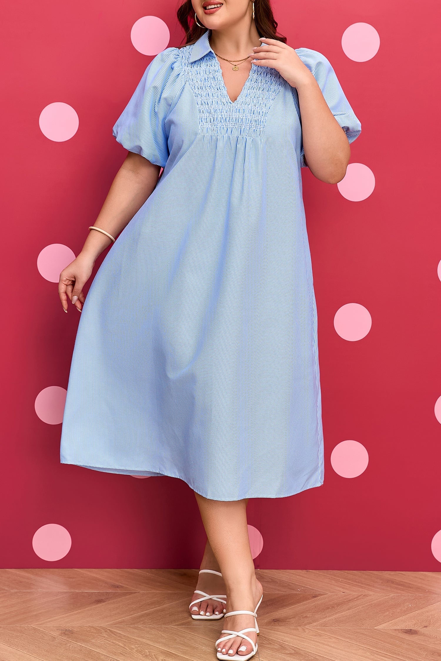 Plus-size light blue striped midi dress with V-neck and puff sleeves; knee-length view.